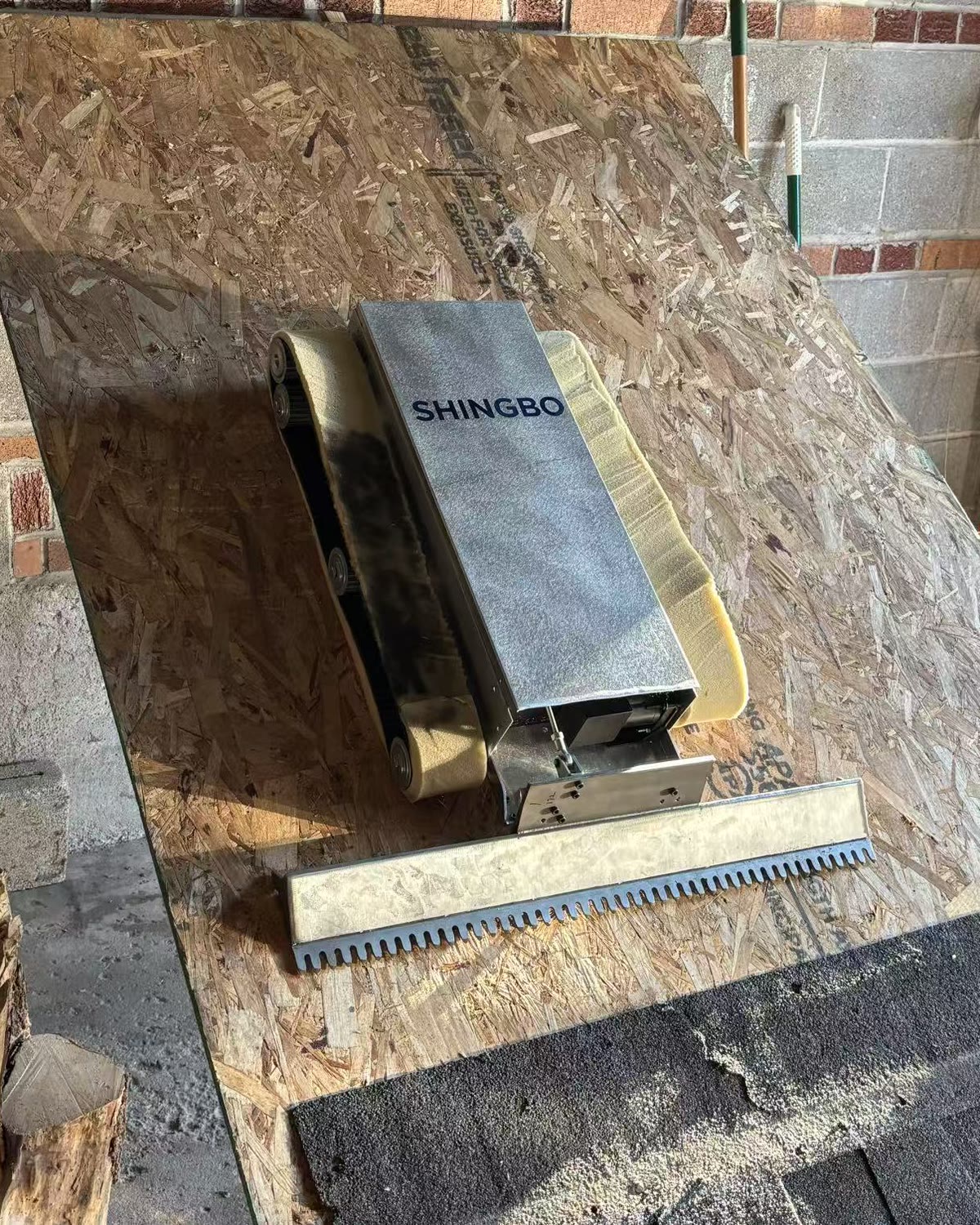 Shingbo roof tear-off robot, a 35 lb roofing robot one person can carry up a ladder